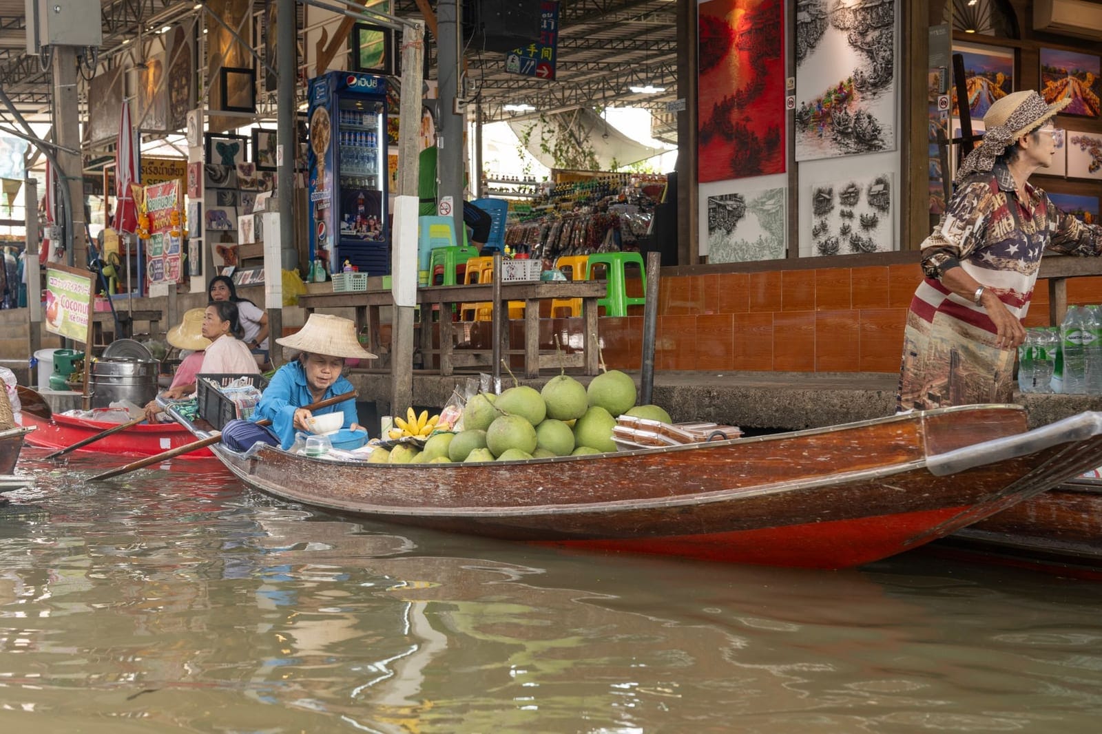 Vendors selling fruit from boats at a floating market in Thailand